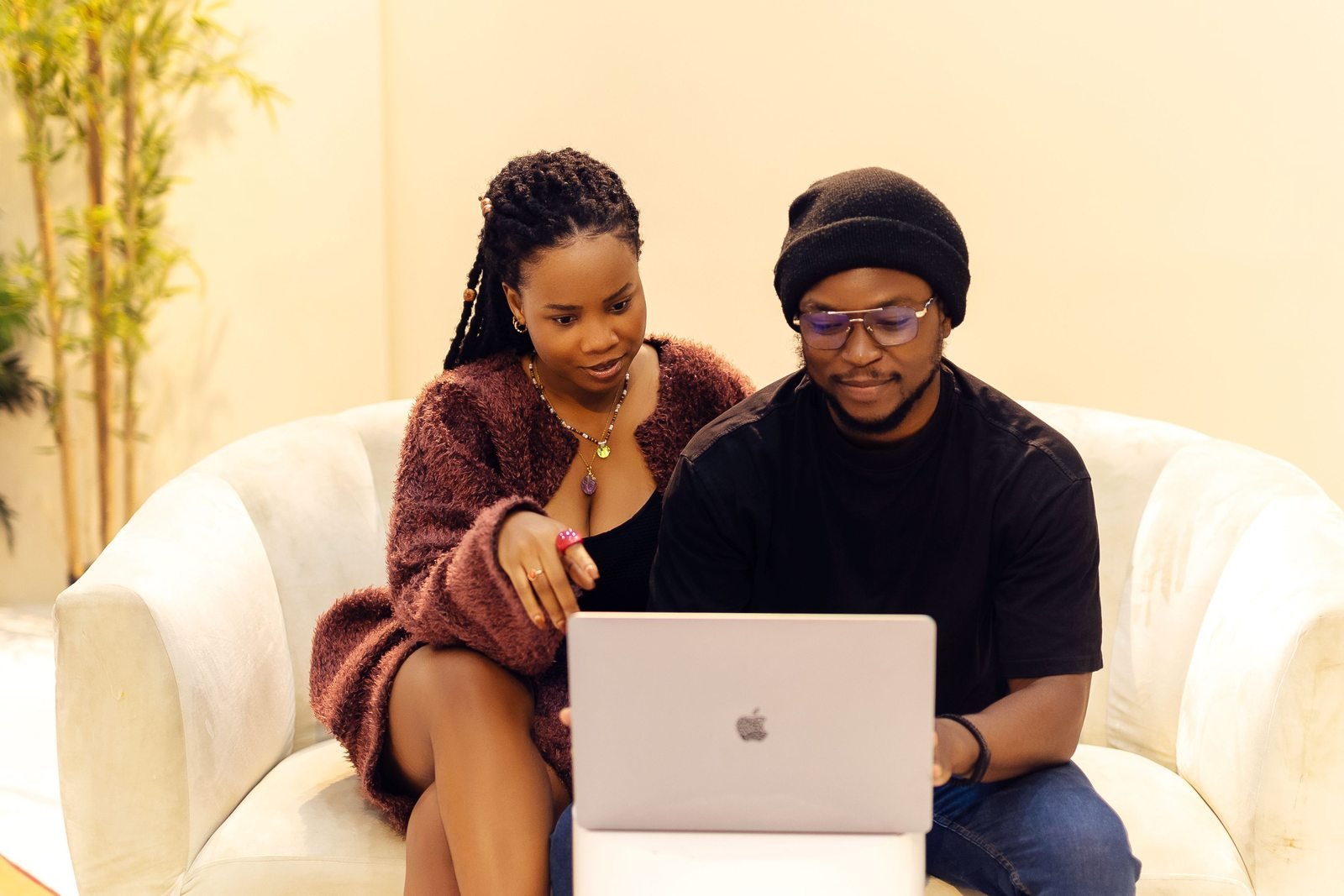Deux jeunes professionnels réfléchissent ensemble devant un ordinateur à Lagos.